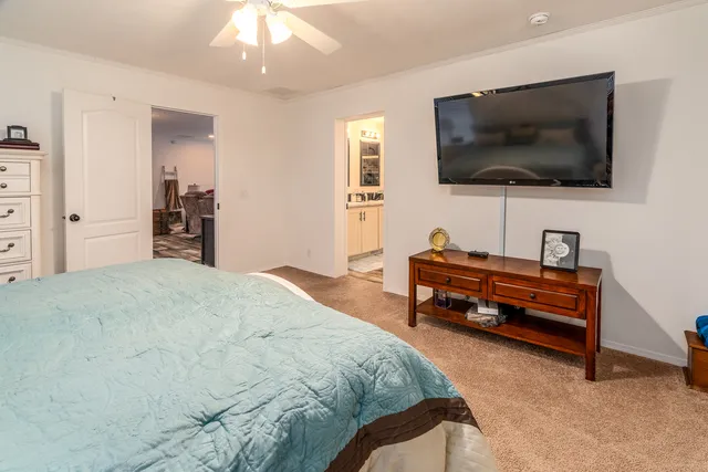a bedroom with a bed and a flat screen tv