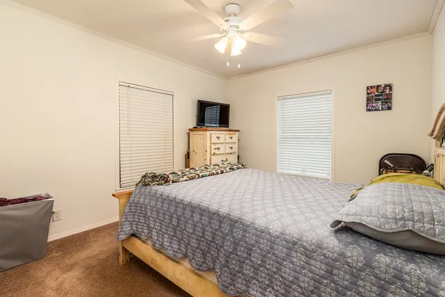 a bedroom with a bed and a television