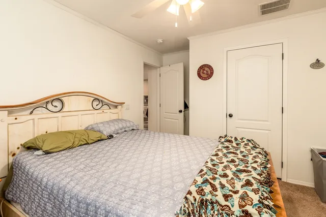 a bedroom with a bed and a mirror