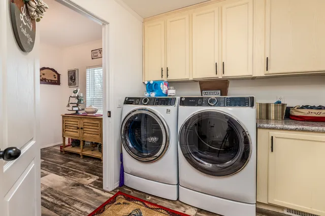 a utility room with sink dryer and washer