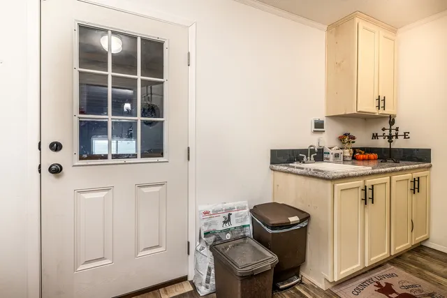 a room with a chair and cabinets