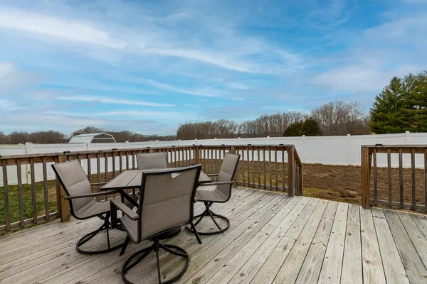 a view of a deck with chairs and wooden floor
