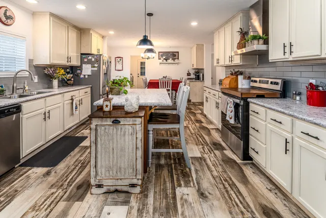a kitchen with kitchen island granite countertop lots of counter top space and appliances