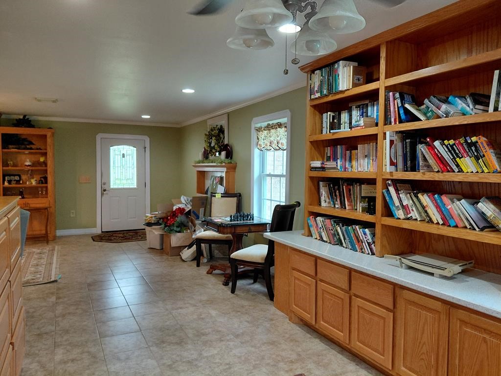 1231 County Road 201A Angleton, TX 77515 - Photo 20 of 26 a living room with lots of books