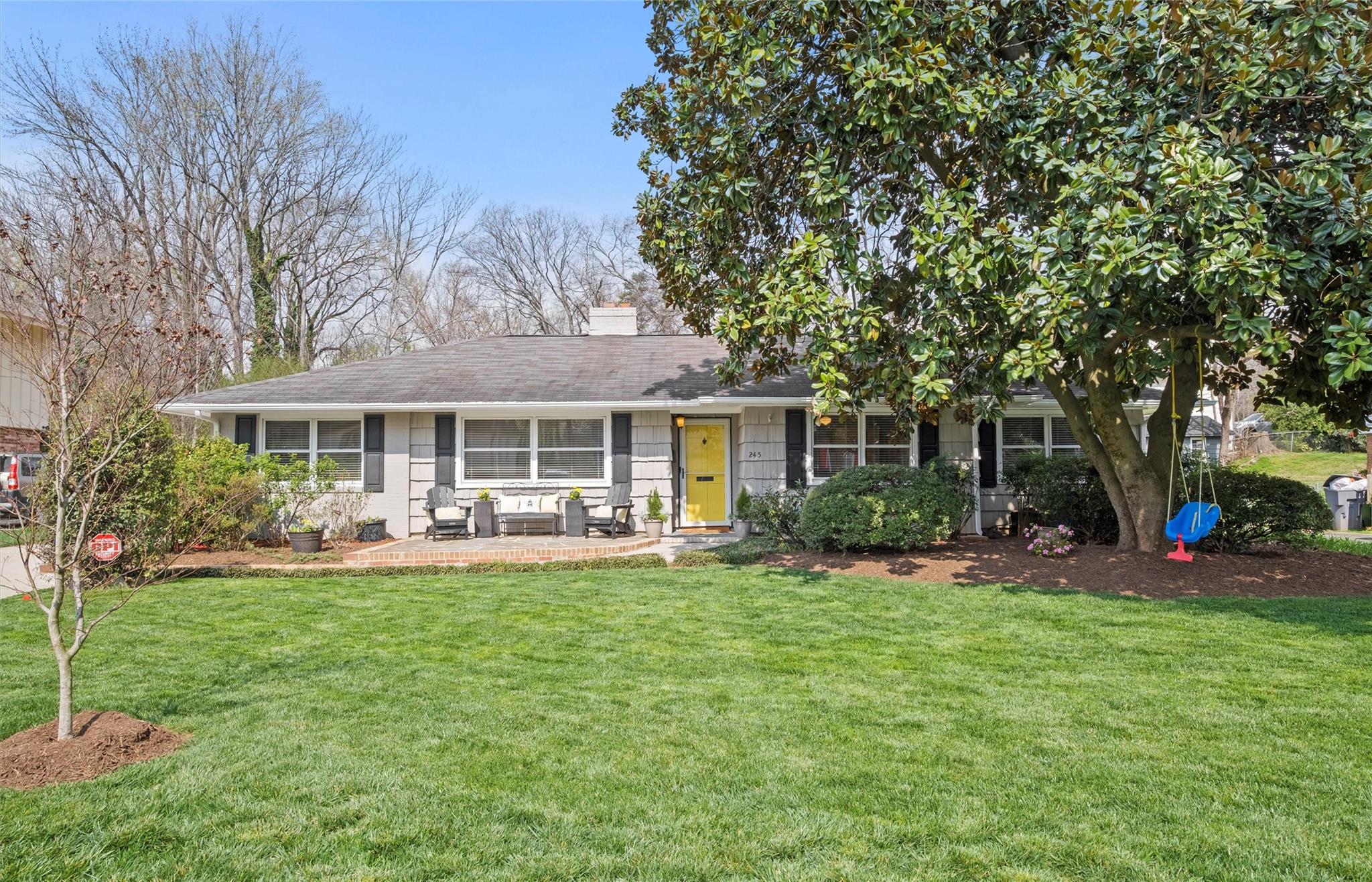 a front view of a house with a yard and patio