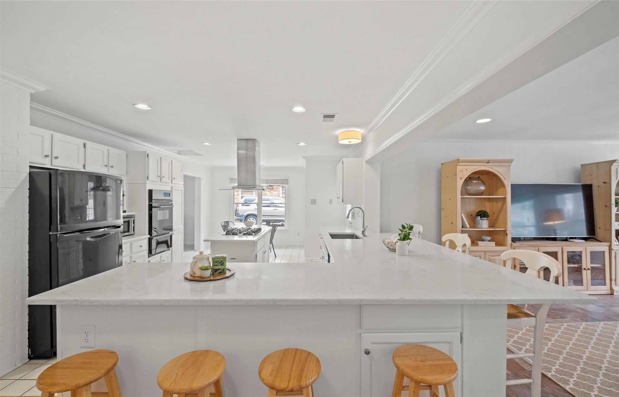 245 Scofield Road Charlotte, NC 28209 - Photo 11 of 33 a kitchen with stainless steel appliances granite countertop a sink a stove a refrigerator cabinets and chairs