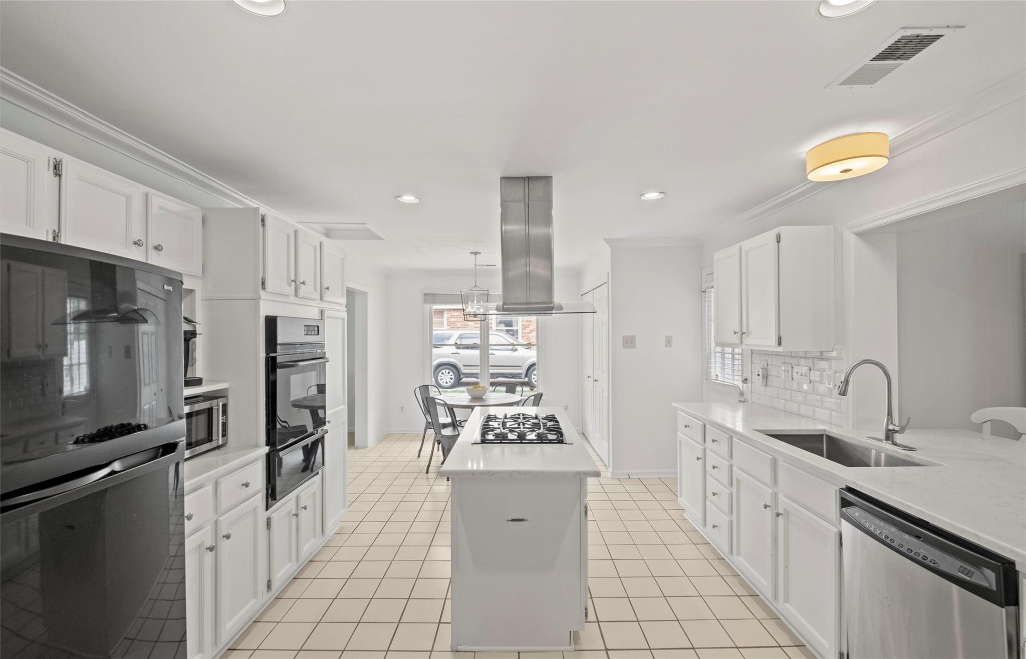 245 Scofield Road Charlotte, NC 28209 - Photo 12 of 33 a kitchen with stainless steel appliances a sink stove refrigerator and cabinets