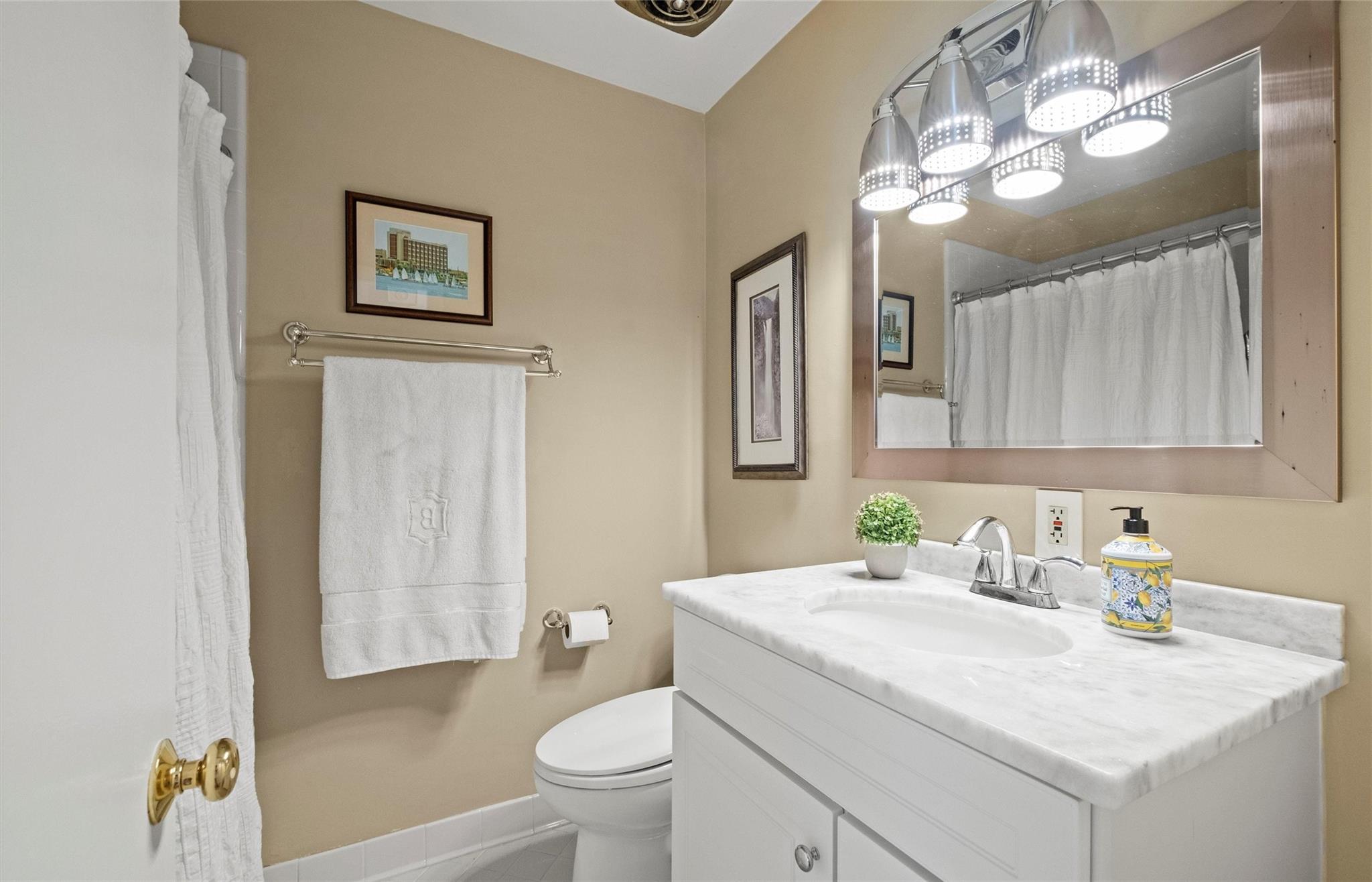245 Scofield Road Charlotte, NC 28209 - Photo 22 of 33 a bathroom with a granite countertop sink a toilet and a mirror