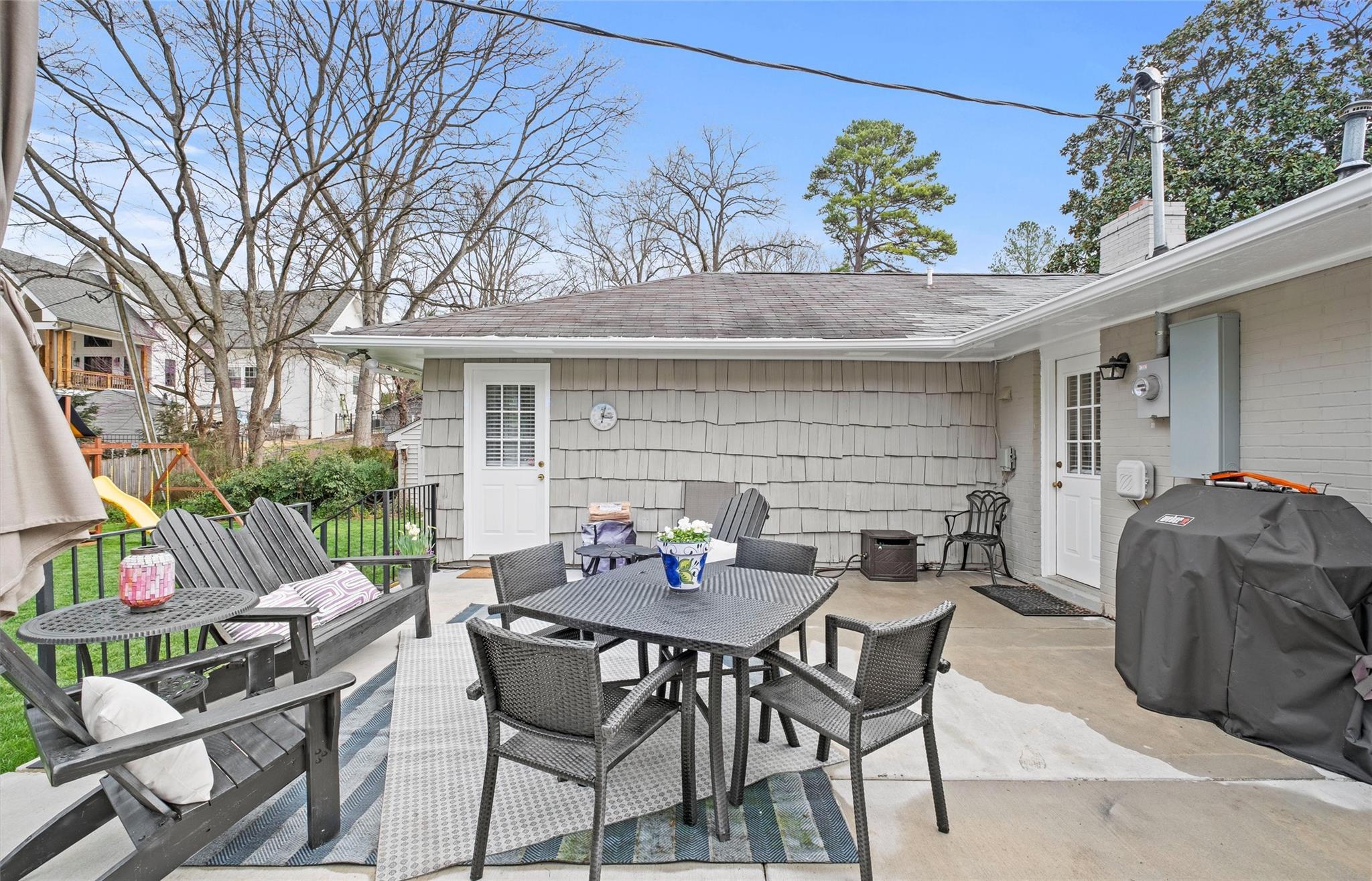 245 Scofield Road Charlotte, NC 28209 - Photo 28 of 33 a view of a patio with table and chairs with wooden floor and fence