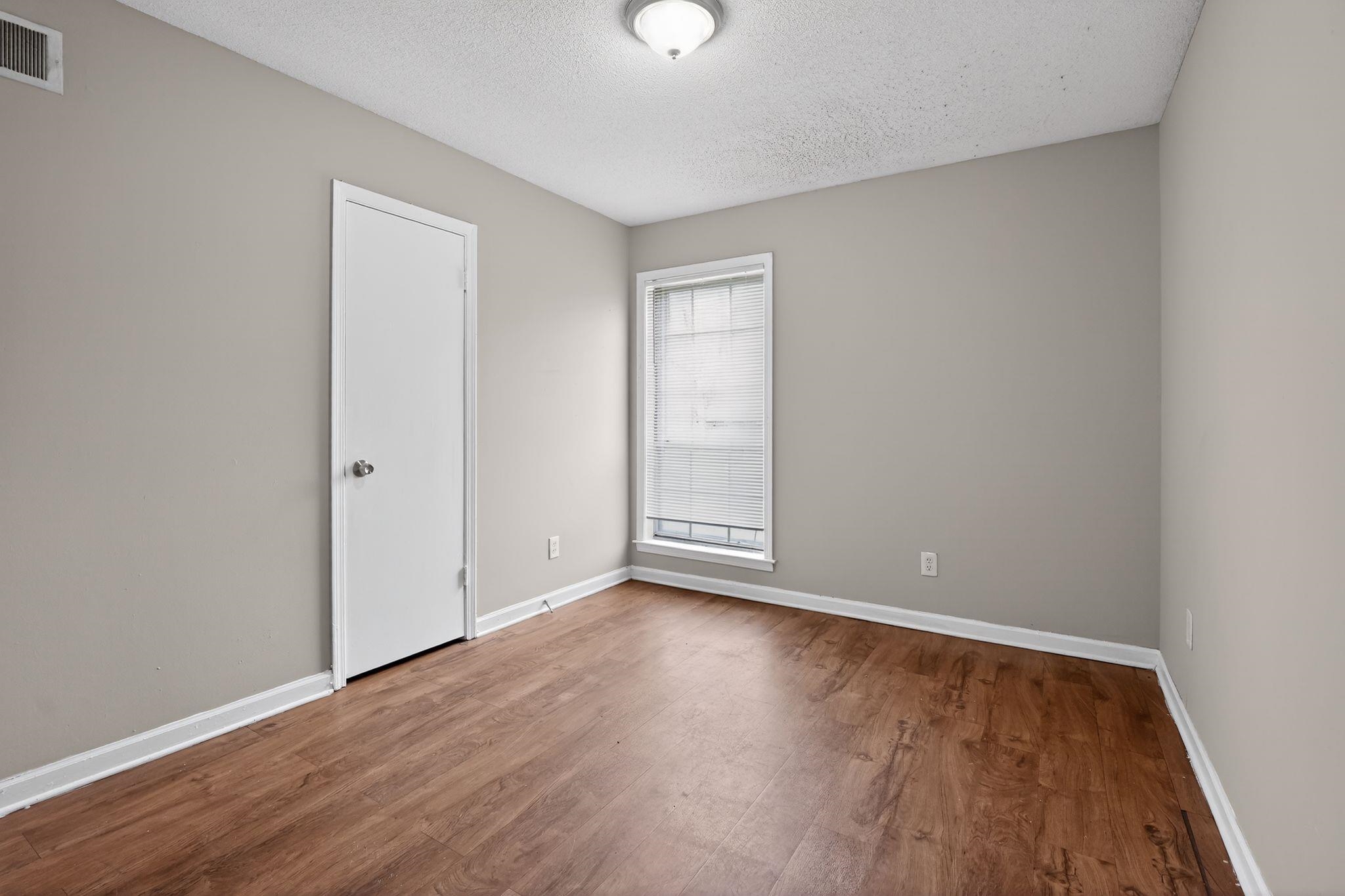 4094 Double Tree Street Memphis, TN 38109 - Photo 11 of 31 Spare room with a textured ceiling and dark wood finished floors