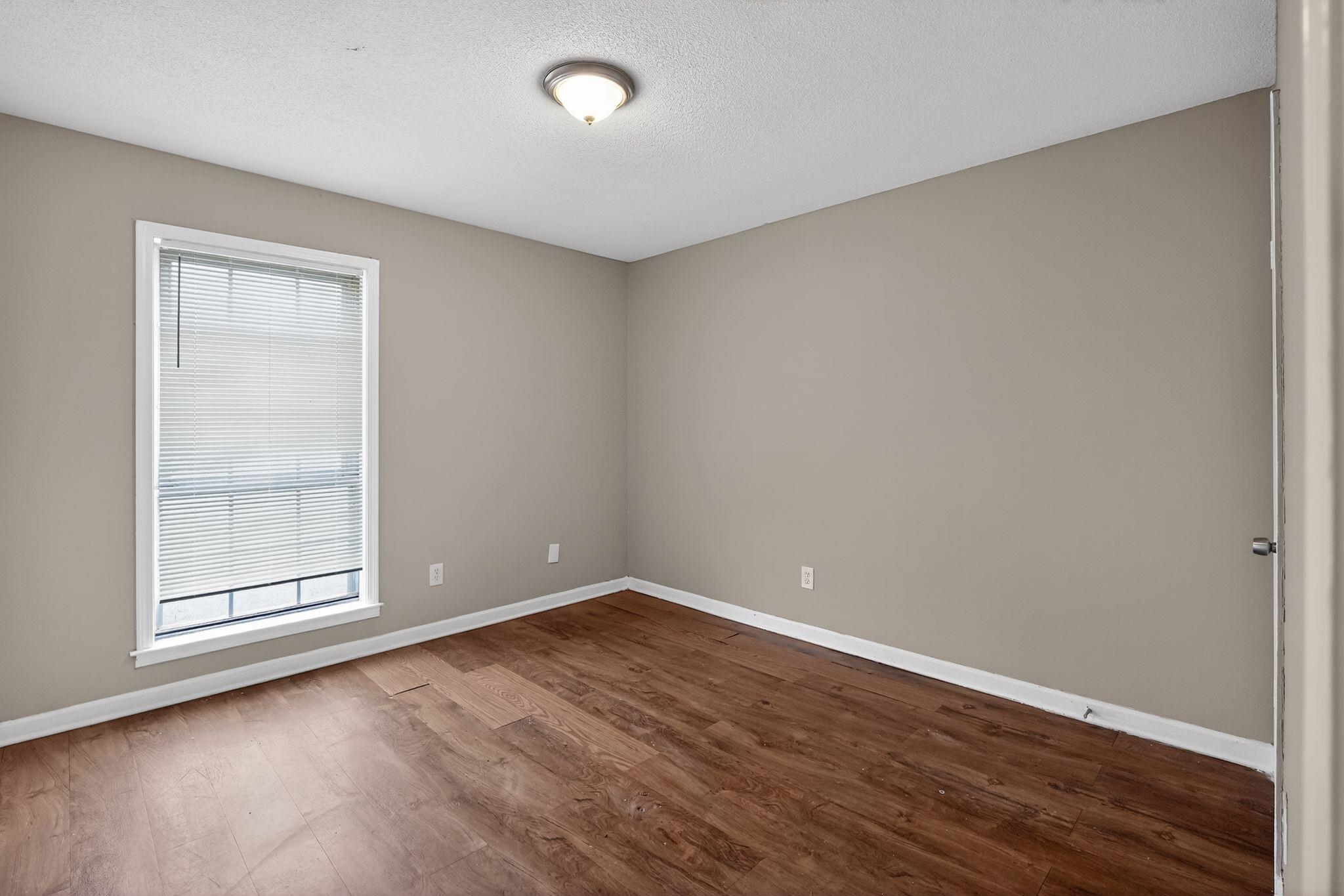4094 Double Tree Street Memphis, TN 38109 - Photo 17 of 31 Empty room featuring dark wood-type flooring and a textured ceiling