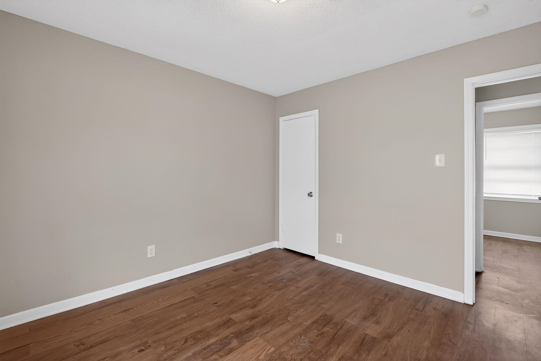 4094 Double Tree Street Memphis, TN 38109 - Photo 18 of 31 Spare room with baseboards and dark wood-style flooring