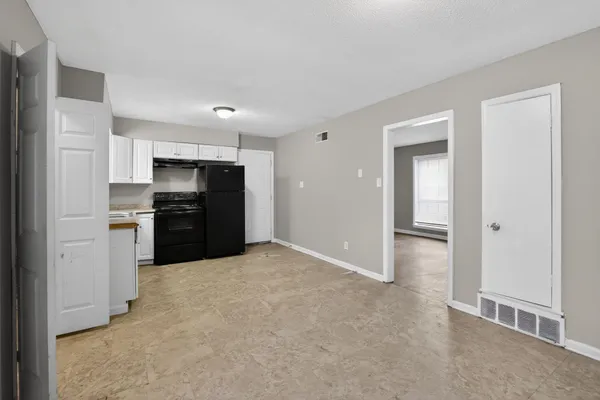 a kitchen with stainless steel appliances granite countertop a refrigerator and a stove top oven