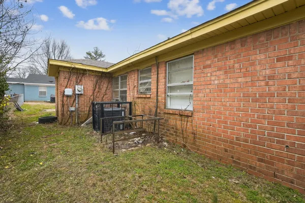 a backyard of a house with table and chairs