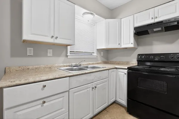 a kitchen with a stove and a refrigerator