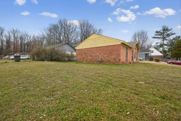 a view of a yard with a house in the background