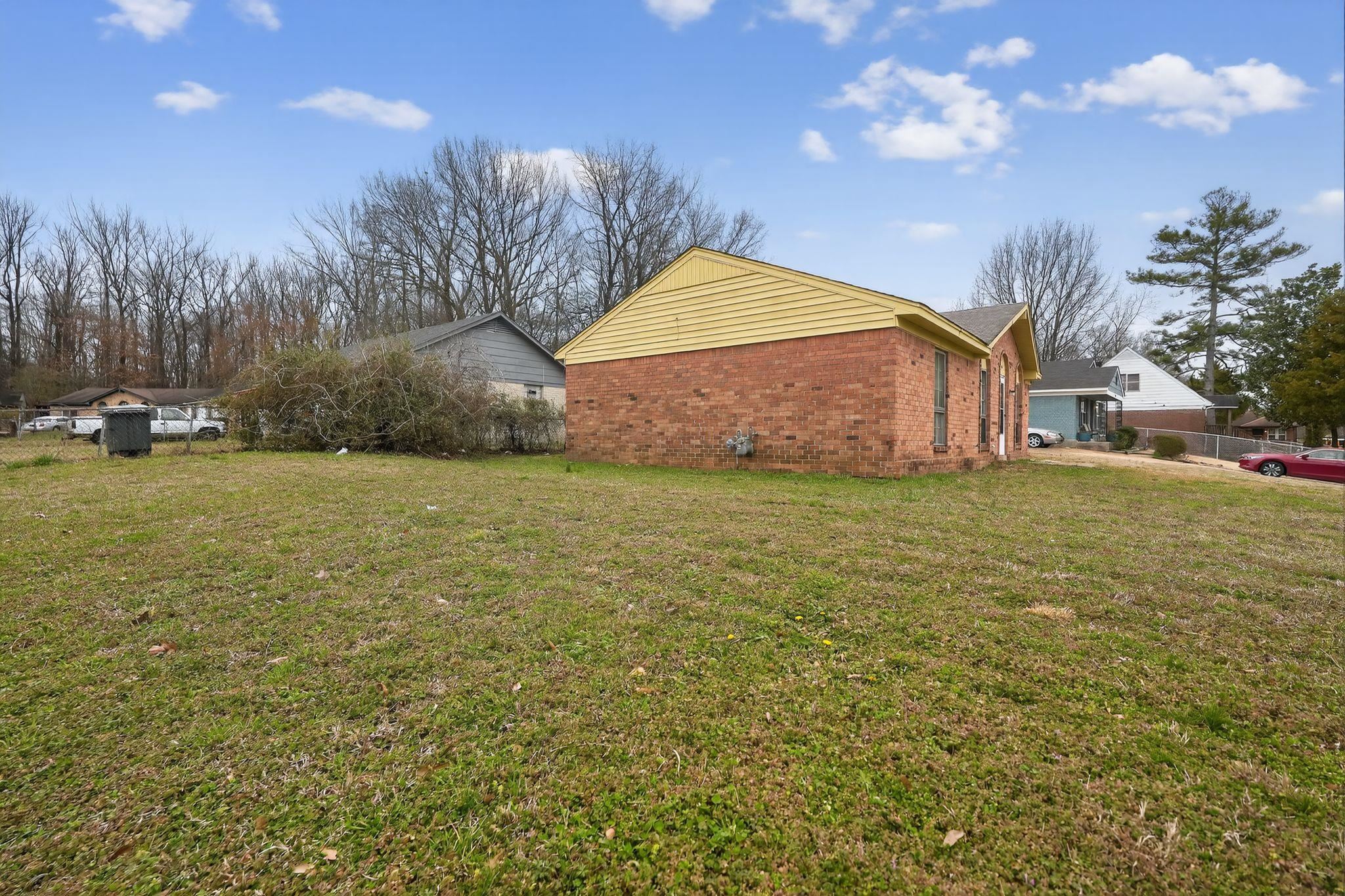 4094 Double Tree Street Memphis, TN 38109 - Photo 5 of 31 View of side of property featuring brick siding and a lawn