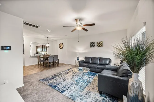 a living room with furniture and a rug