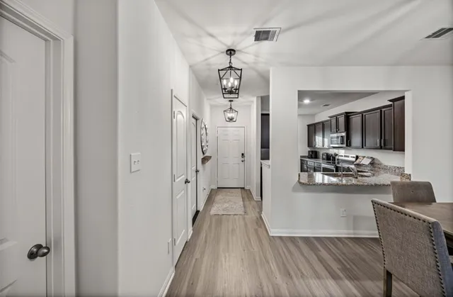 a view of a kitchen from the hallway