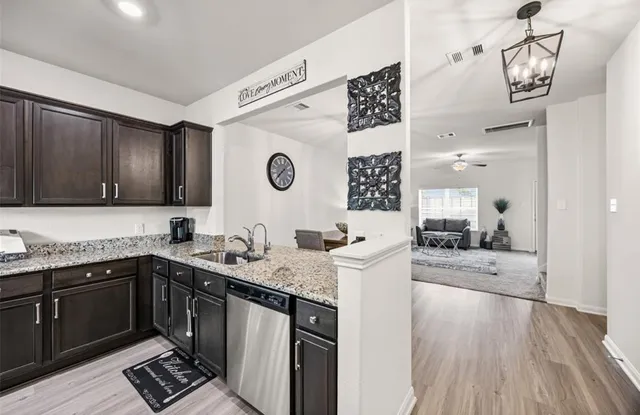 a kitchen with a sink and a stove top oven