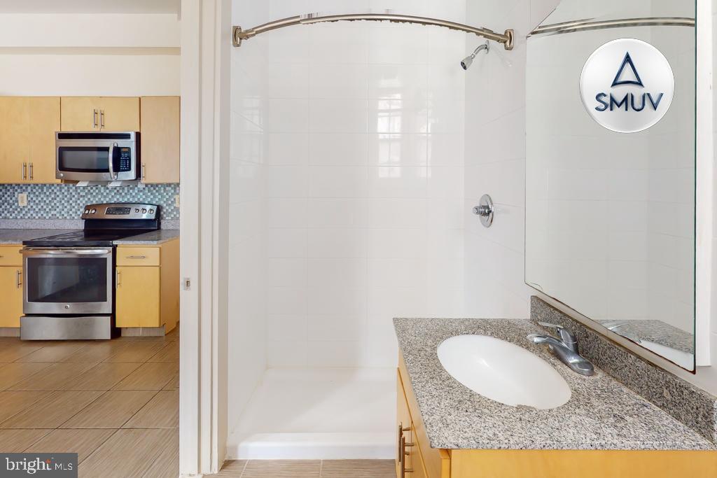11 East Chase Street, Unit 506 Baltimore, MD 21202 - Photo 18 of 32 Modern kitchen and sleek bathroom design.