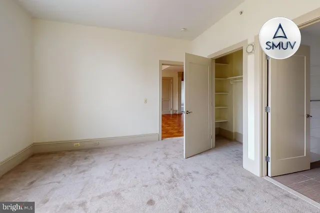 a view of a room with wall a kitchen space with a refrigerator