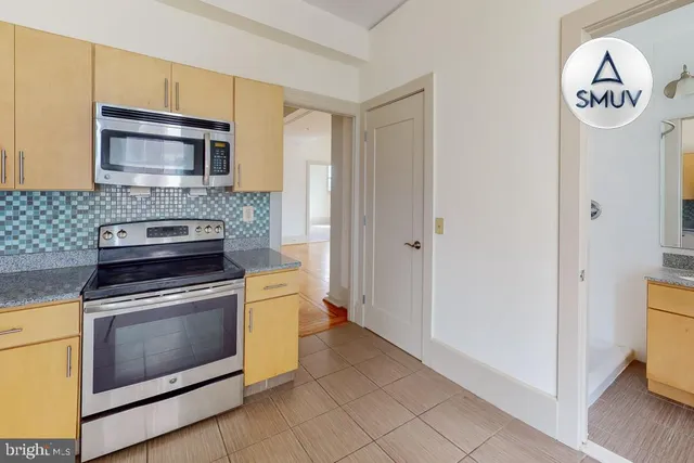 a kitchen with a stove and a microwave
