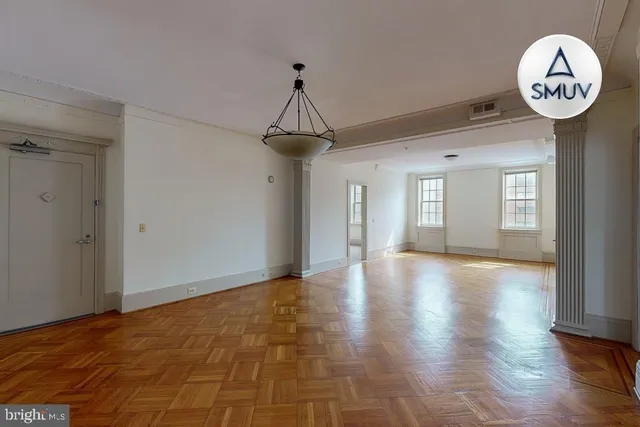 a view of a hallway with a chandelier fan