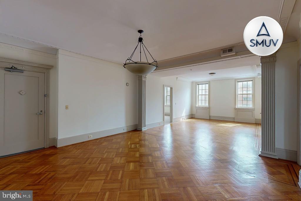 11 East Chase Street, Unit 506 Baltimore, MD 21202 - Photo 7 of 32 Spacious, sunlit room with elegant flooring.
