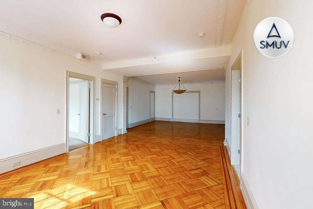 11 East Chase Street, Unit 506 Baltimore, MD 21202 - Photo 8 of 32 Spacious room with elegant parquet flooring.