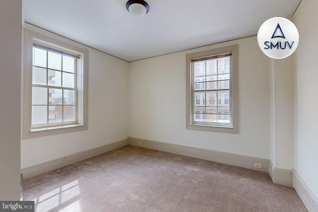 11 East Chase Street, Unit 506 Baltimore, MD 21202 - Photo 9 of 32 Bright and airy room with charming windows.