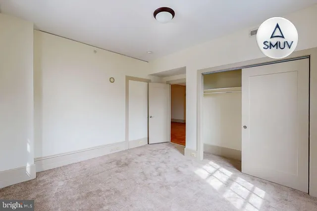 a view of a hallway to a closet area