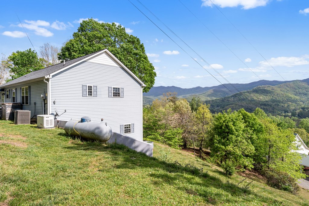 619 Pounding Mill Loop Hayesville, NC 28904 - Photo 17 of 54 a house with lots of trees in the background