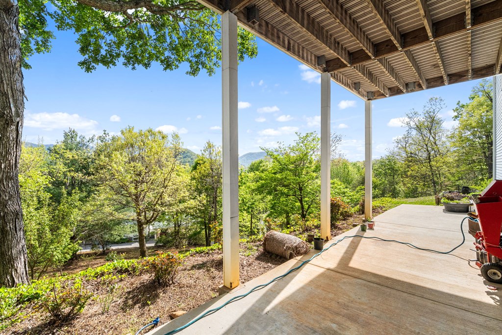 619 Pounding Mill Loop Hayesville, NC 28904 - Photo 19 of 54 a view of a porch with furniture and a yard