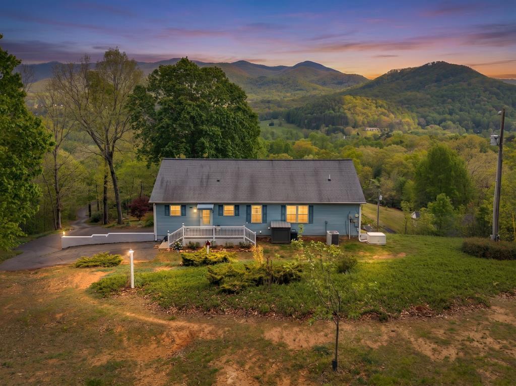 619 Pounding Mill Loop Hayesville, NC 28904 - Photo 2 of 54 a view of a house with a yard