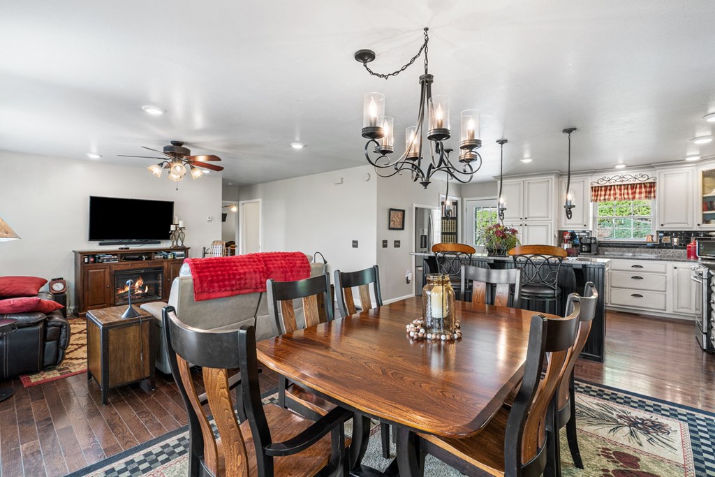 619 Pounding Mill Loop Hayesville, NC 28904 - Photo 31 of 54 a view of a dining room with furniture and wooden floor