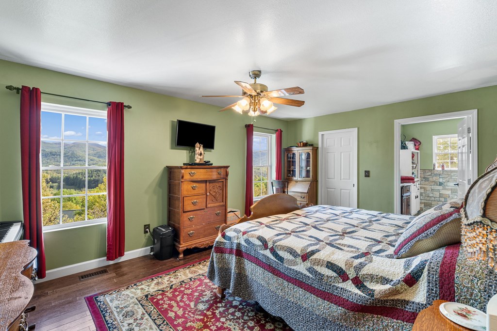 619 Pounding Mill Loop Hayesville, NC 28904 - Photo 34 of 54 a bedroom with a bed and a chandelier