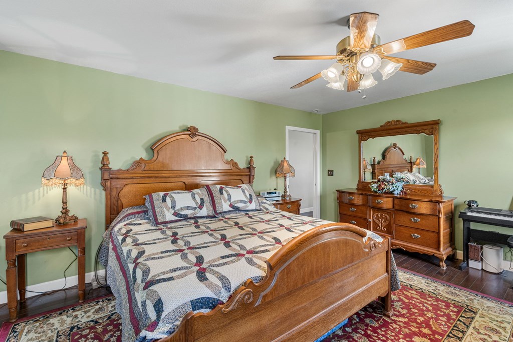 619 Pounding Mill Loop Hayesville, NC 28904 - Photo 35 of 54 a bedroom with a bed and a chandelier