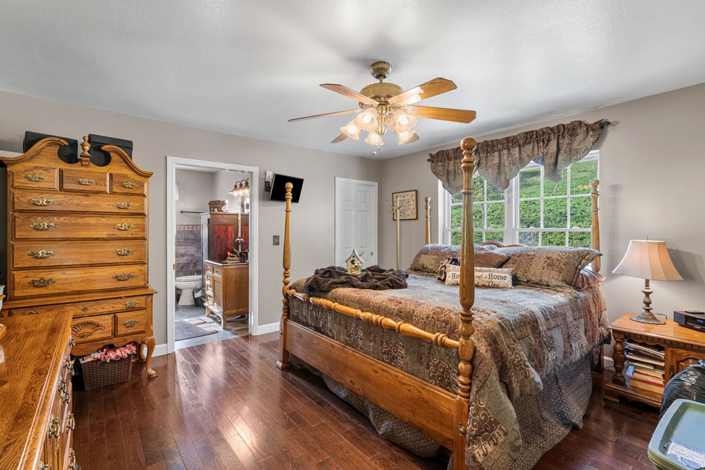 619 Pounding Mill Loop Hayesville, NC 28904 - Photo 38 of 54 a bedroom with a bed and wooden floor