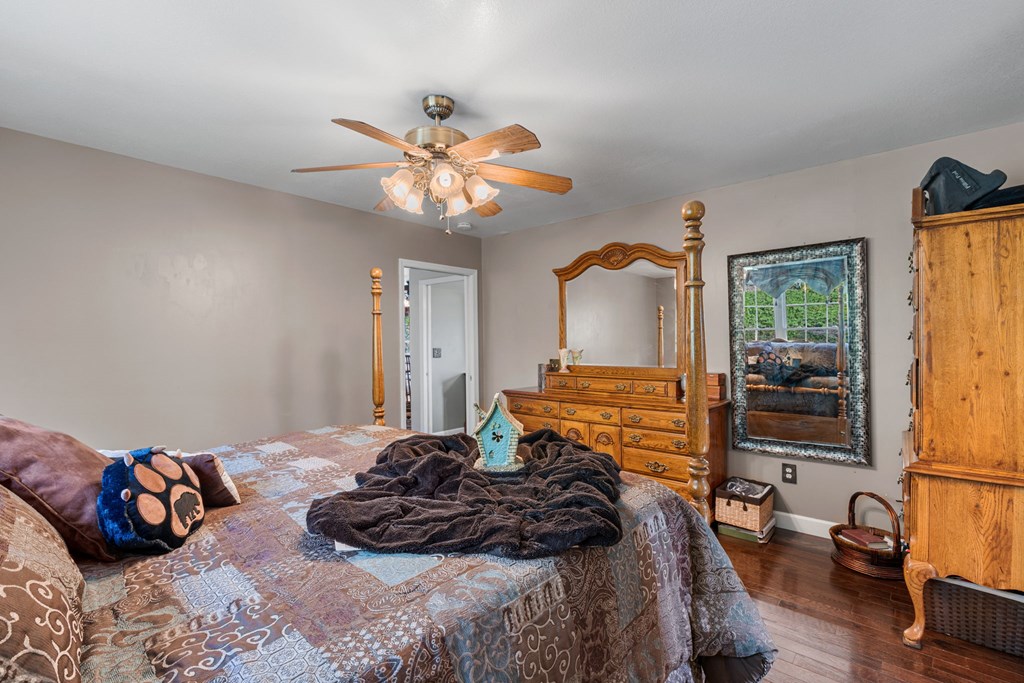 619 Pounding Mill Loop Hayesville, NC 28904 - Photo 39 of 54 a bedroom with a bed and wooden floor