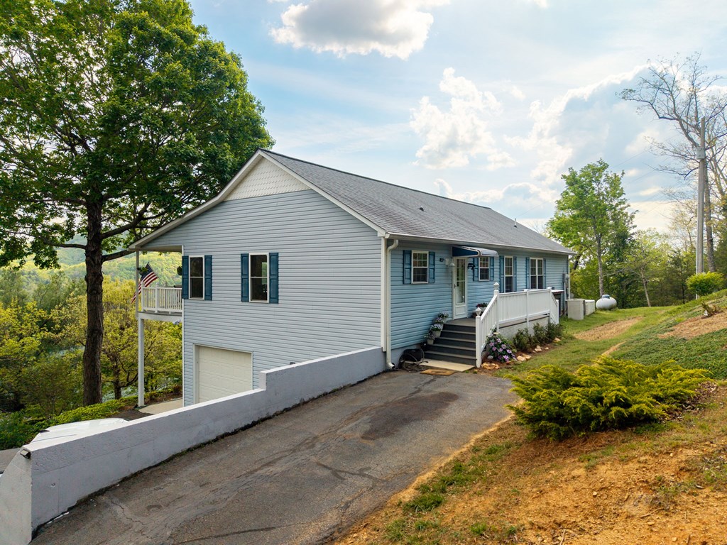619 Pounding Mill Loop Hayesville, NC 28904 - Photo 5 of 54 a front view of a house with garden