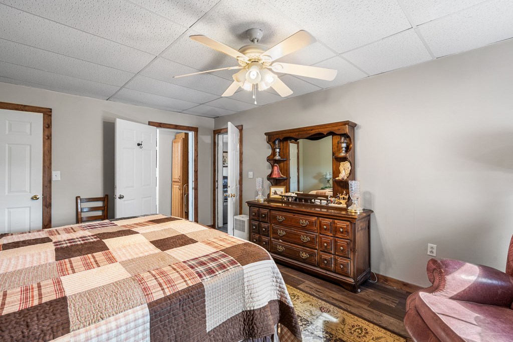 619 Pounding Mill Loop Hayesville, NC 28904 - Photo 52 of 54 a bedroom with a bed and wooden floor