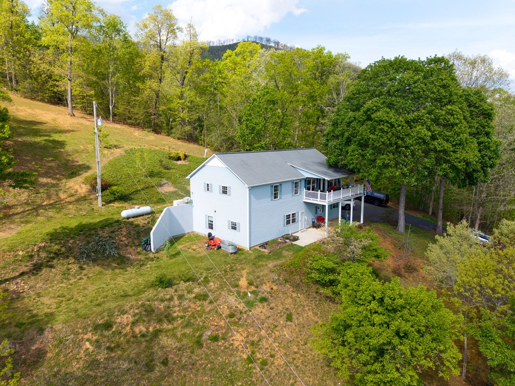619 Pounding Mill Loop Hayesville, NC 28904 - Photo 7 of 54 a house is sitting in middle of the green field
