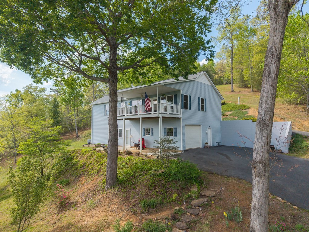619 Pounding Mill Loop Hayesville, NC 28904 - Photo 10 of 54 a front view of a house with garden
