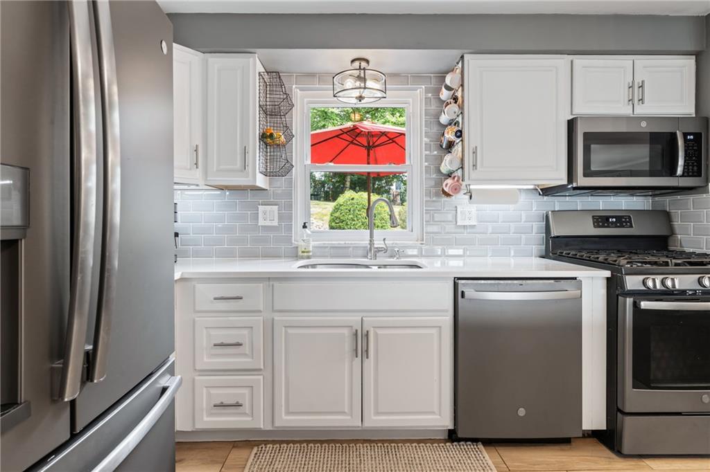 9342 Doral Drive Pittsburgh, PA 15237 - Photo 11 of 40 a kitchen with stainless steel appliances granite countertop a refrigerator and a sink