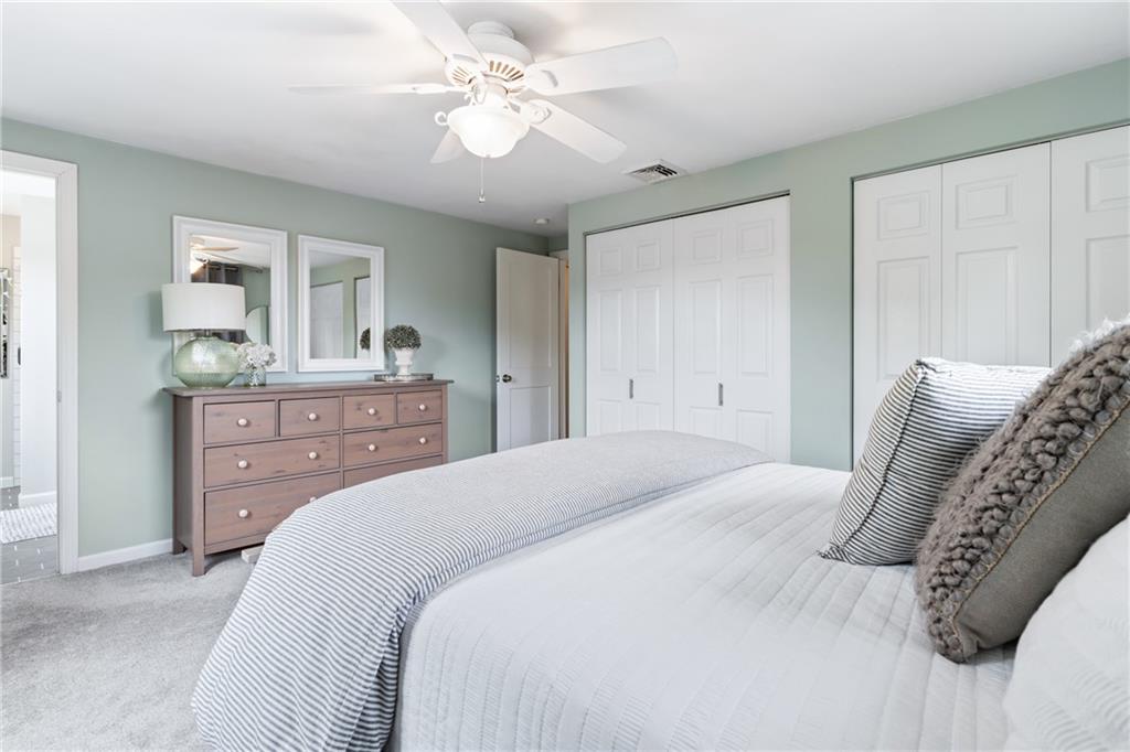 9342 Doral Drive Pittsburgh, PA 15237 - Photo 23 of 40 a bedroom with a bed and a chandelier