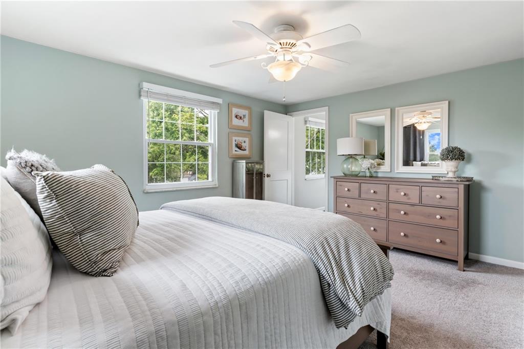 9342 Doral Drive Pittsburgh, PA 15237 - Photo 24 of 40 a bedroom with a large bed and a chandelier