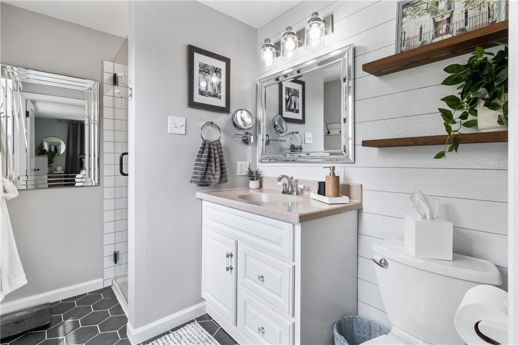 9342 Doral Drive Pittsburgh, PA 15237 - Photo 26 of 40 a bathroom with a sink a toilet and mirror