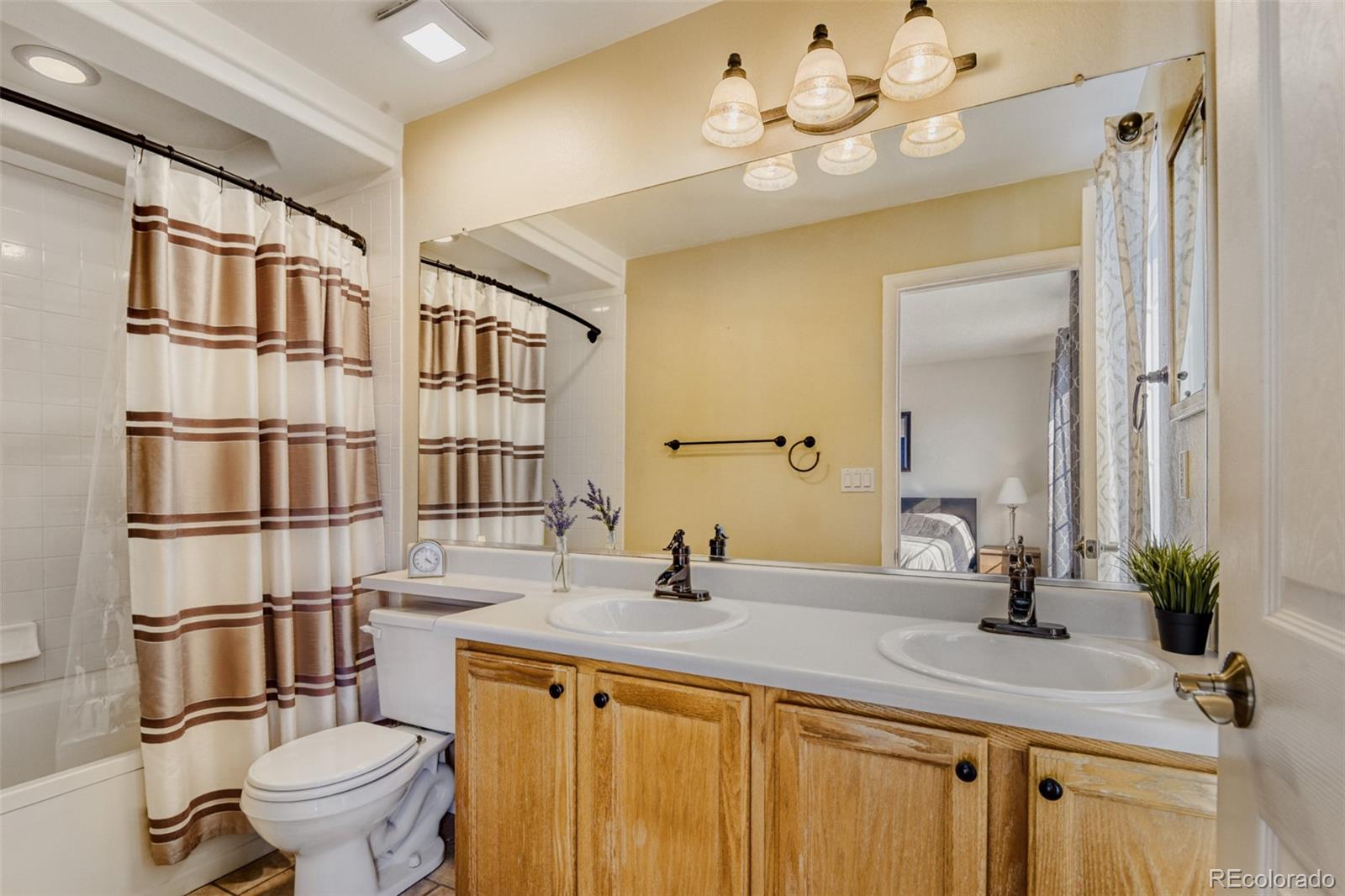 9649 Adelaide Circle Highlands Ranch, CO 80130 - Photo 19 of 32 a bathroom with a double vanity sink mirror and toilet