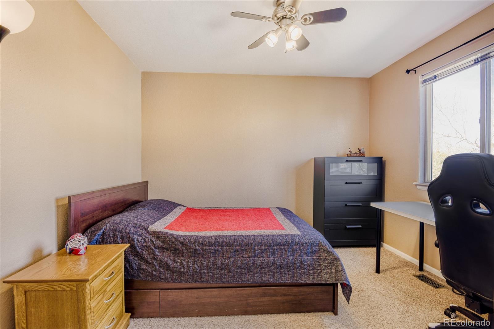 9649 Adelaide Circle Highlands Ranch, CO 80130 - Photo 21 of 32 a bedroom with a bed and wooden floor